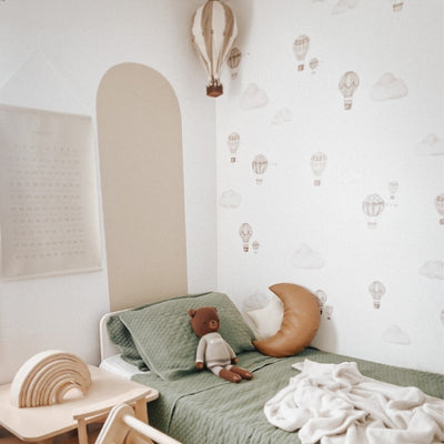 Picture of a children's room with light brown and beige hot air balloon and clouds wall decals