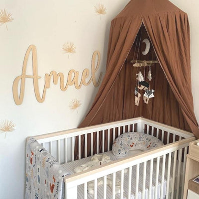 Picture of a boho baby nursery with beige palm floral wall decals