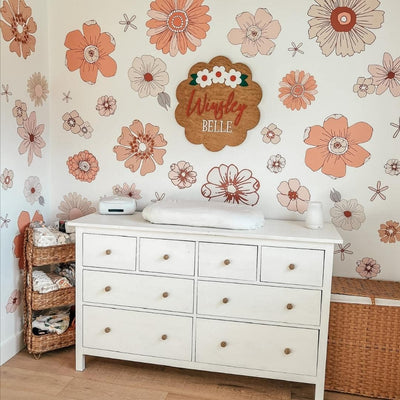 Picture of a baby nursery with large peach and pink retro flower wall decals