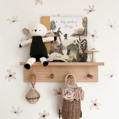 Picture of a shelf for children with dusty rose and vintage white flower wall decals