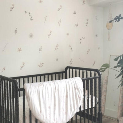Picture of a nursery with muted floral and leaves wall decals