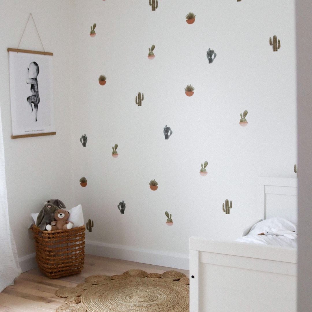 Bedroom with fabric wall decals featuring a variety of cacti and plants, showcasing vibrant colours that bring a touch of nature indoors. 