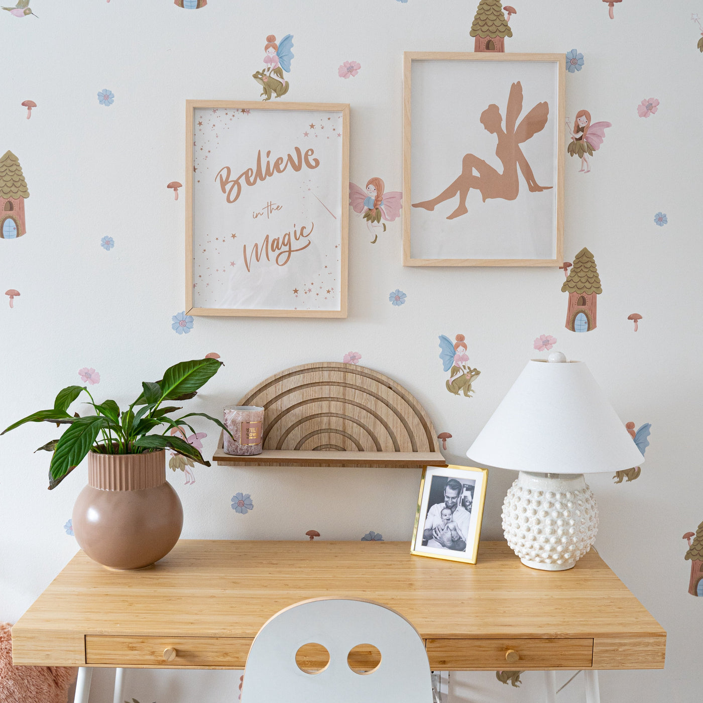 A whimsical little girls bedroom featuring colourful fairy wall decals surrounded by soft flowers, charming mushrooms, and enchanting fairy houses, creating a magical atmosphere. 