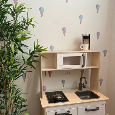 Fun and vibrant fabric wall decals showcasing colourful ice cream cones in a playroom. These non-toxic decals are removable, making them a delightful addition to any space, perfect for kids' rooms or ice cream-themed areas.