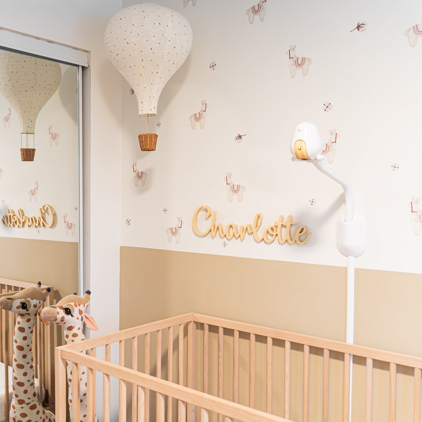 Neutral fabric wall decals featuring cute llamas and fluffy cotton balls in a nursery, perfect for adding a whimsical touch to any space.