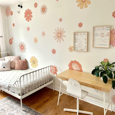 Large fabric wall decals showcasing vibrant boho flowers in peach and apricot in a little girls room, perfect for adding a bold and artistic flair. 