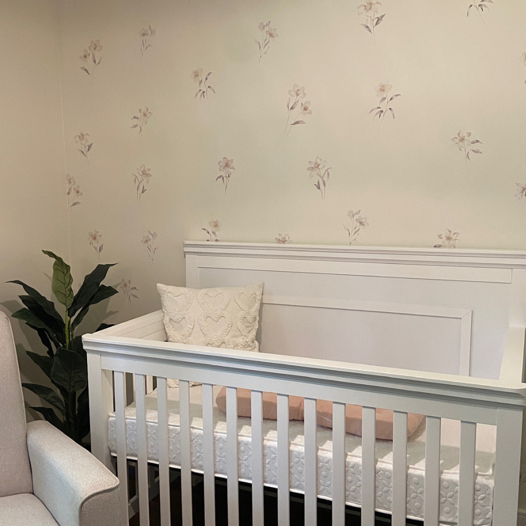 Elegant lily flowers fabric wall decals featuring soft, beautiful colours in a nursery . These non-toxic and removable decals bring a touch of sophistication and nature to any room, ideal for bedrooms, living areas, or bathrooms, creating a serene and calming atmosphere. 