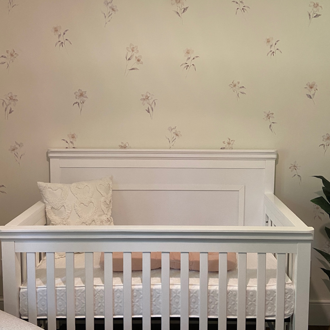 Elegant lily flowers fabric wall decals featuring soft, beautiful colours in a nursery . These non-toxic and removable decals bring a touch of sophistication and nature to any room, ideal for bedrooms, living areas, or bathrooms, creating a serene and calming atmosphere. 