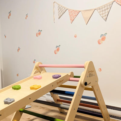 Fabric wall decals featuring charming peaches in a playroom, adding a fresh and fruity vibe 