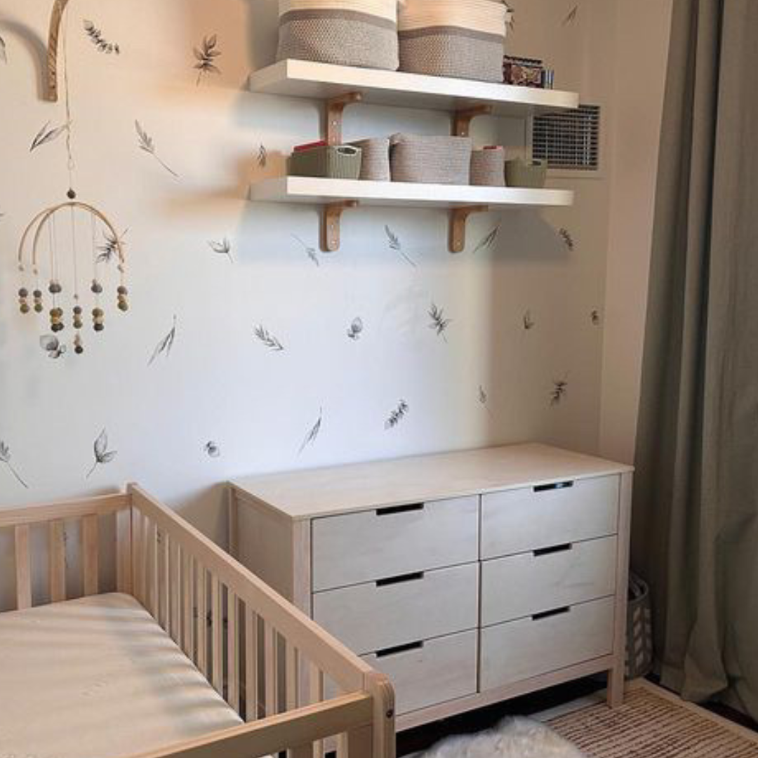 Fabric wall decals featuring elegant sage leaves in a nursery, perfect for introducing a refreshing and natural element. 