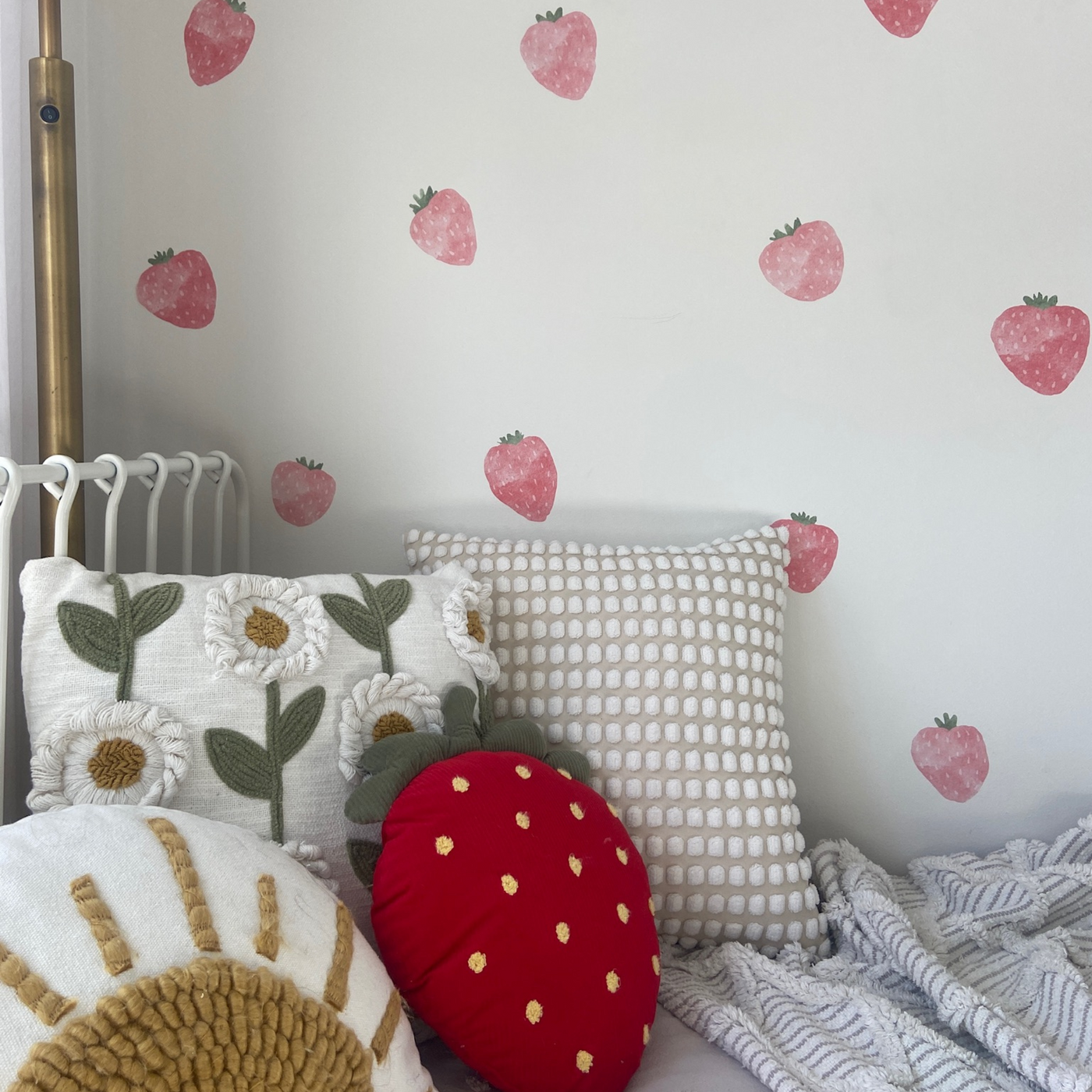 Fabric wall decals featuring vibrant strawberries with green leaves in a little girls room, perfect for adding a fresh and cheerful touch. 