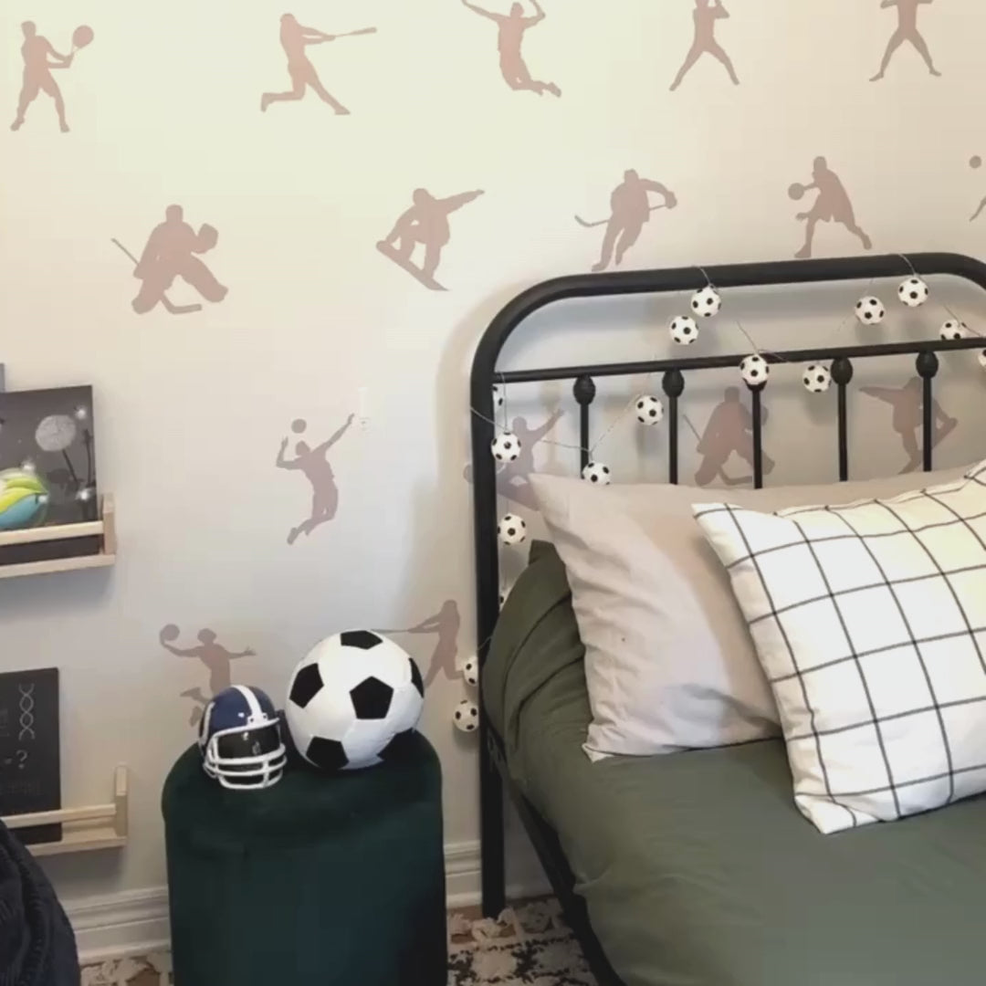 Video of fabric wall decals featuring dynamic sport players in action in a child's room. Perfect for inspiring young athletes and adding a sporty vibe. 