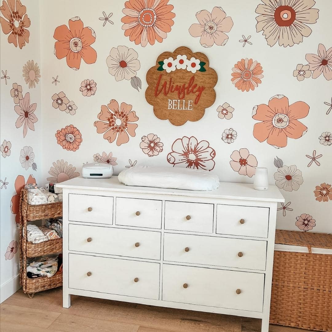 A bedroom with a collection of large boho-style flowers in various sizes, featuring shades of peach, beige, and orange, to create a vibrant and warm floral display.