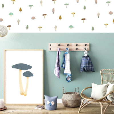 Charming boho mushroom fabric wall decals in muted neutral colours, creating a whimsical and earthy atmosphere in a childs playroom. 