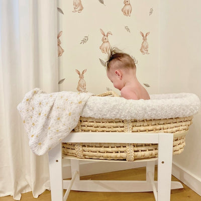 Soft fabric wall decals featuring playful bunnies surrounded by various leaves, creating a whimsical and nature-inspired decor in a babies nursery. 