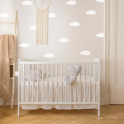 Soft and whimsical fabric wall decals in a nursery with fluffy white clouds, perfect for creating a dreamy atmosphere in a child's bedroom or nursery.