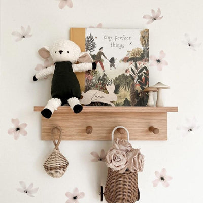 Elegant fabric wall decals featuring a soft dusty rose colour paired with vintage white flowers in a little girls room, crafted from non-toxic materials, perfect for creating a serene and stylish atmosphere in any room.
