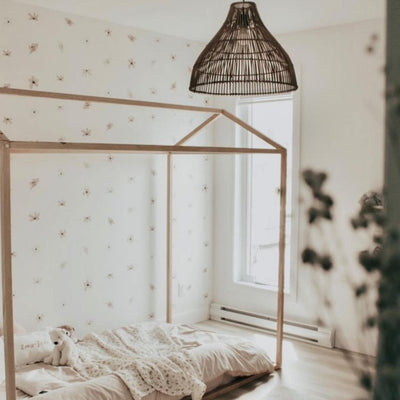 Elegant fabric wall decals featuring a soft dusty rose colour paired with vintage white flowers in a little girls room, crafted from non-toxic materials, perfect for creating a serene and stylish atmosphere in any room.
