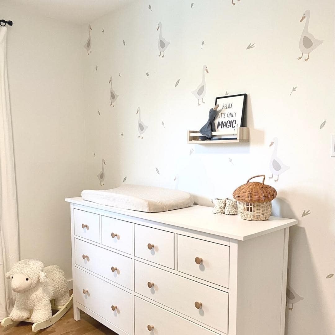 Charming fabric wall decals featuring geese among delicate leaves in a nursery. These non-toxic decals are removable, adding a whimsical and nature-inspired touch to any room's decor.