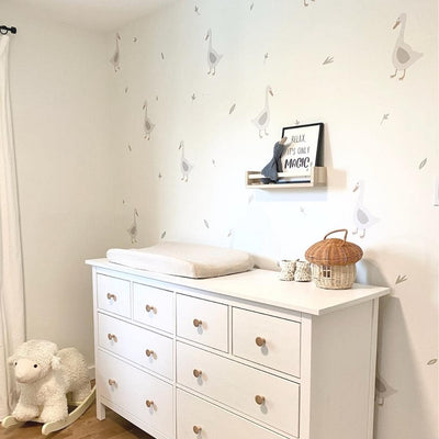 Charming fabric wall decals featuring geese among delicate leaves in a nursery. These non-toxic decals are removable, adding a whimsical and nature-inspired touch to any room's decor.