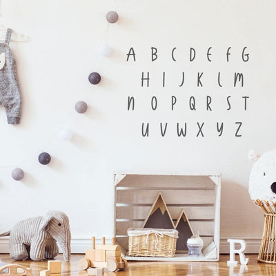 Picture of a children's playroom with dark grey hand drawn alphabet wall decals