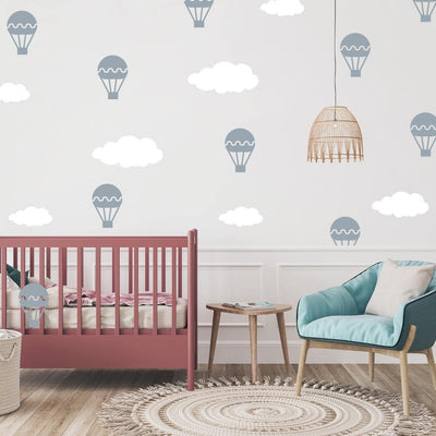 Soft and whimsical fabric wall decals featuring  hot air balloons and clouds in a nursery. These non-toxic decals are removable and perfect for adding a calming and dreamy atmosphere to nurseries or children's rooms.