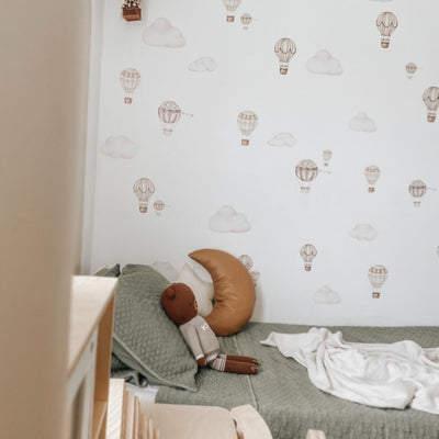 Picture of a children's room  with neutral colour hot air balloons and clouds wall decals