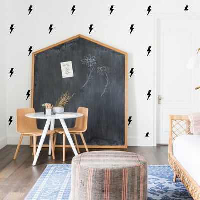 Dynamic lightning bolts fabric wall decals in bold colours in a play room. These non-toxic and removable decals add an energetic and striking element to any room, perfect for children's play areas, bedrooms, or as a unique accent in modern decor.