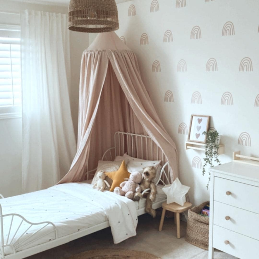 Picture of a bedroom with minimalist rainbow wall decals in dusty rose