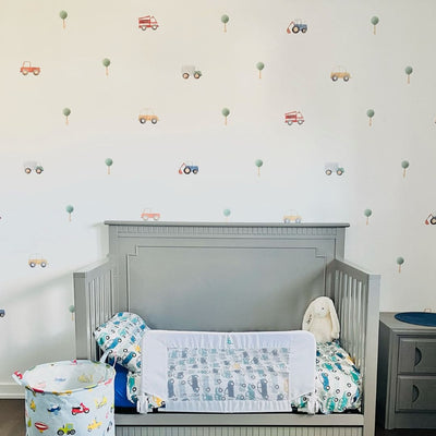 Colourful fabric wall decals in a child's room featuring various designs of cars and trucks, perfect for decorating a child's room or play area