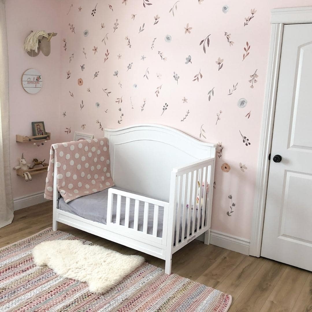 Picture of a nursery with muted floral and leaves wall decals