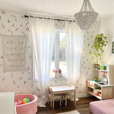 Picture of a play room with muted floral and leaves wall decals